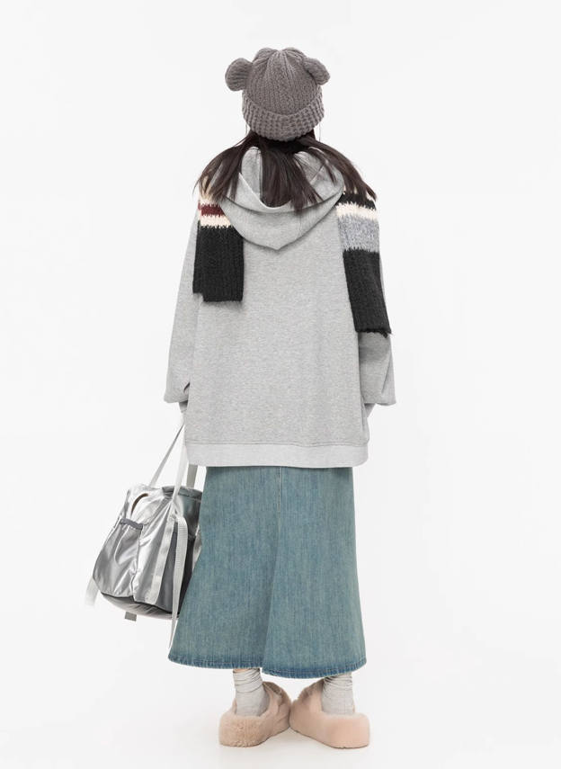 Grey butterfly hoodie styling view highlighting the oversized silhouette, dropped shoulders, long sleeves, and asymmetric hem