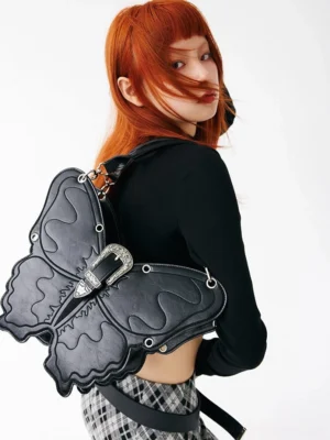 Black 3D punk butterfly bag worn from the back with adjustable shoulder strap and silver buckle hardware