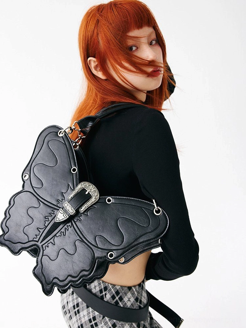 Black 3D punk butterfly bag worn from the back with adjustable shoulder strap and silver buckle hardware