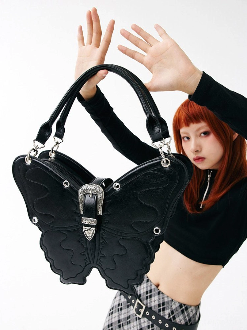 Close-up of black 3D punk butterfly bag showing top handle matte PU texture and silver buckle lock