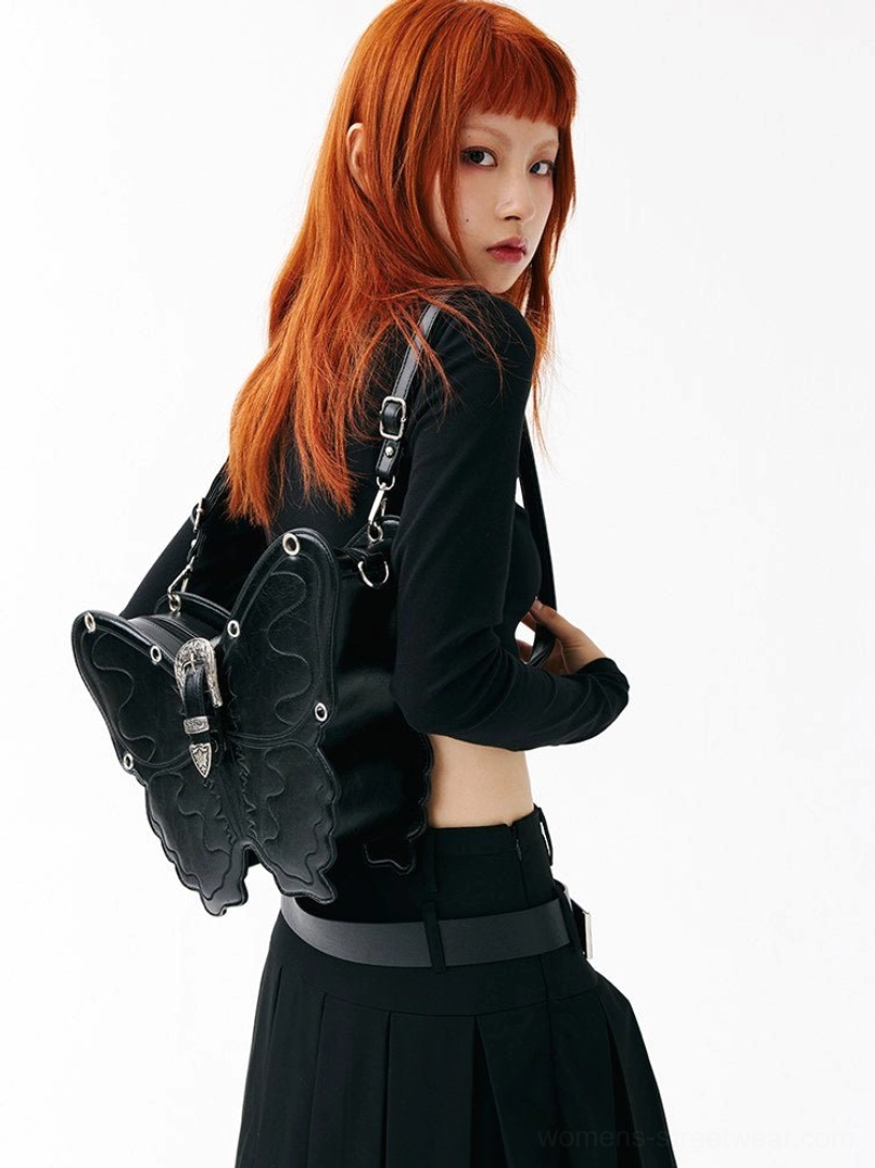 Black punk butterfly shoulder bag worn crossbody with dimensional wings and silver front buckle