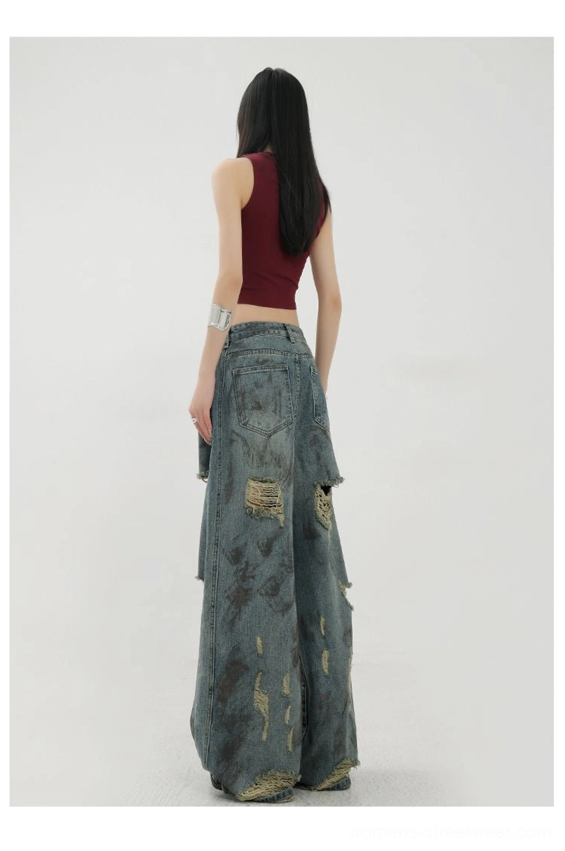 Acubi-inspired blue distressed wide-leg jeans with faded denim texture and oversized relaxed proportions