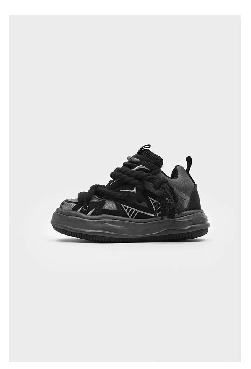 Modern Acubi-inspired chunky sneakers with oversized rope laces, relaxed low-top profile, distressed platform sole, and mixed texture streetwear construction