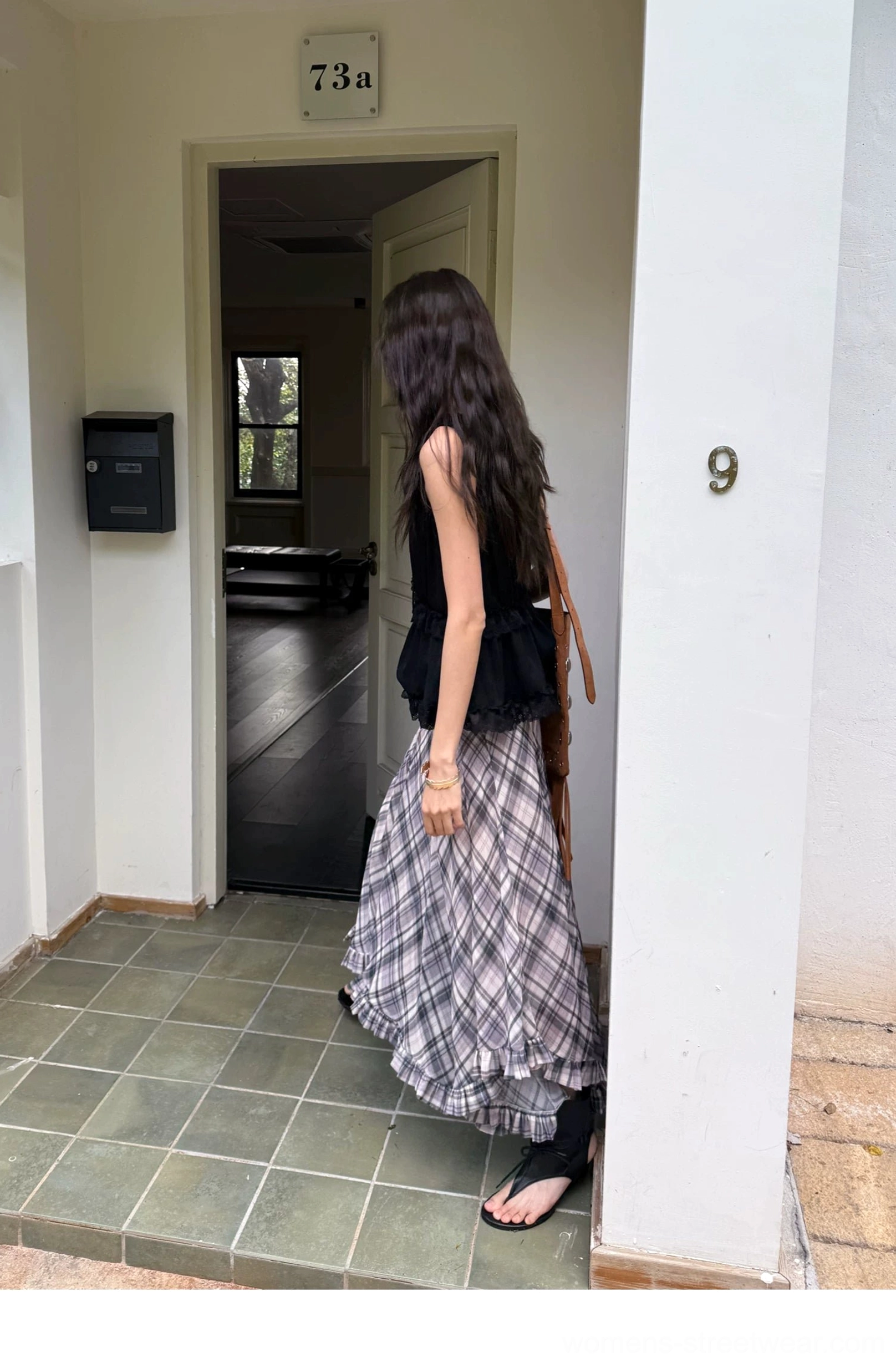 Acubi-inspired plaid chiffon skirt with mid-waist fit layered construction and expressive asymmetric hem