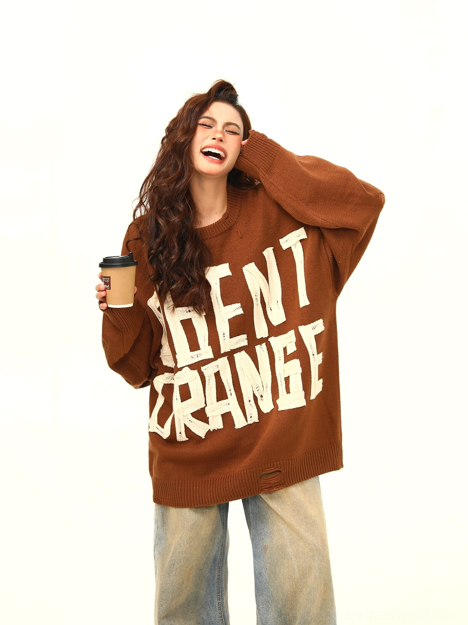 Close front view of brown Agent Orange distressed graphic knit sweater with off white lettering