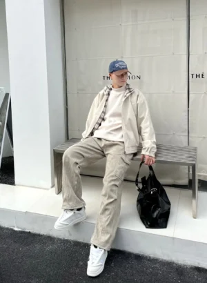 Alien head platform sneakers worn with khaki casual streetwear outfit in an outdoor full-body fashion look