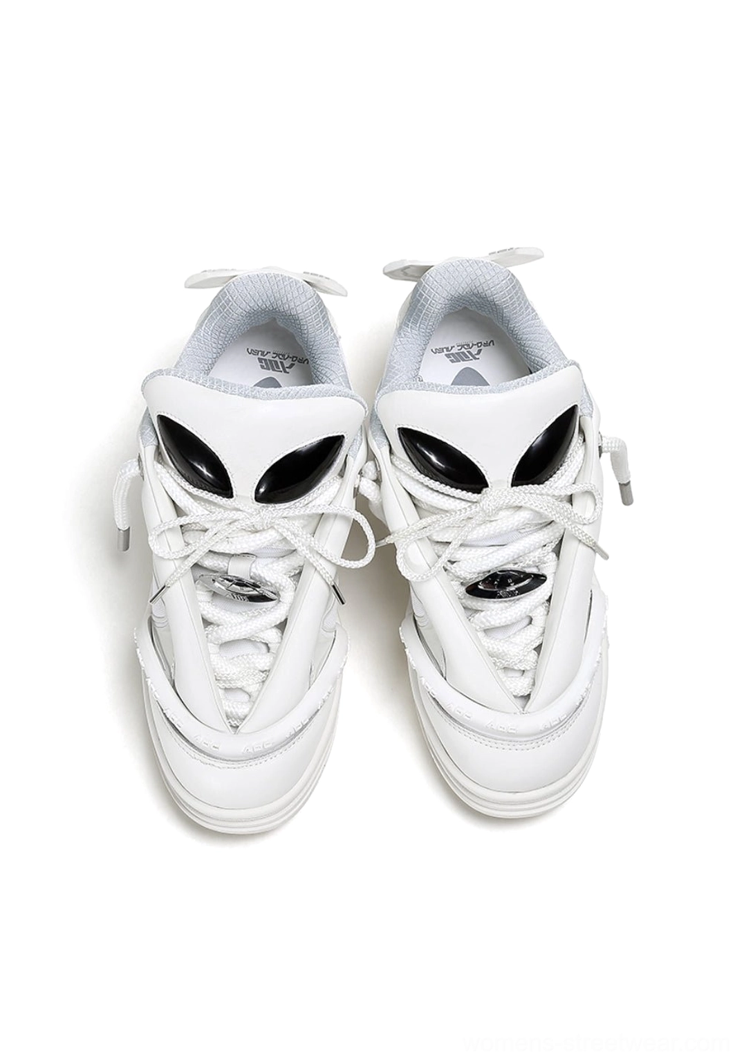 Top front view of white alien head platform sneakers with lace-up fastening and alien tongue decorations
