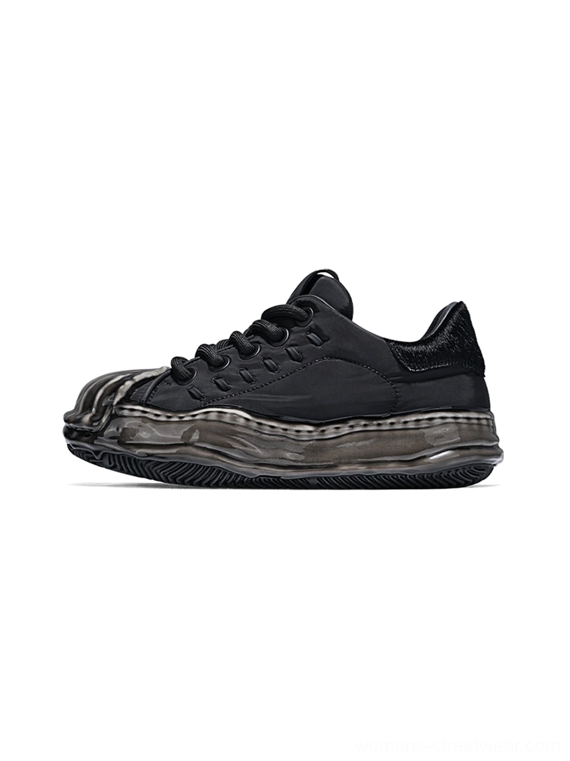 All-black distressed shell-toe leather skate sneaker with smooth black upper, weathered molded toe cap, chunky laces, and unified black sculpted outsole