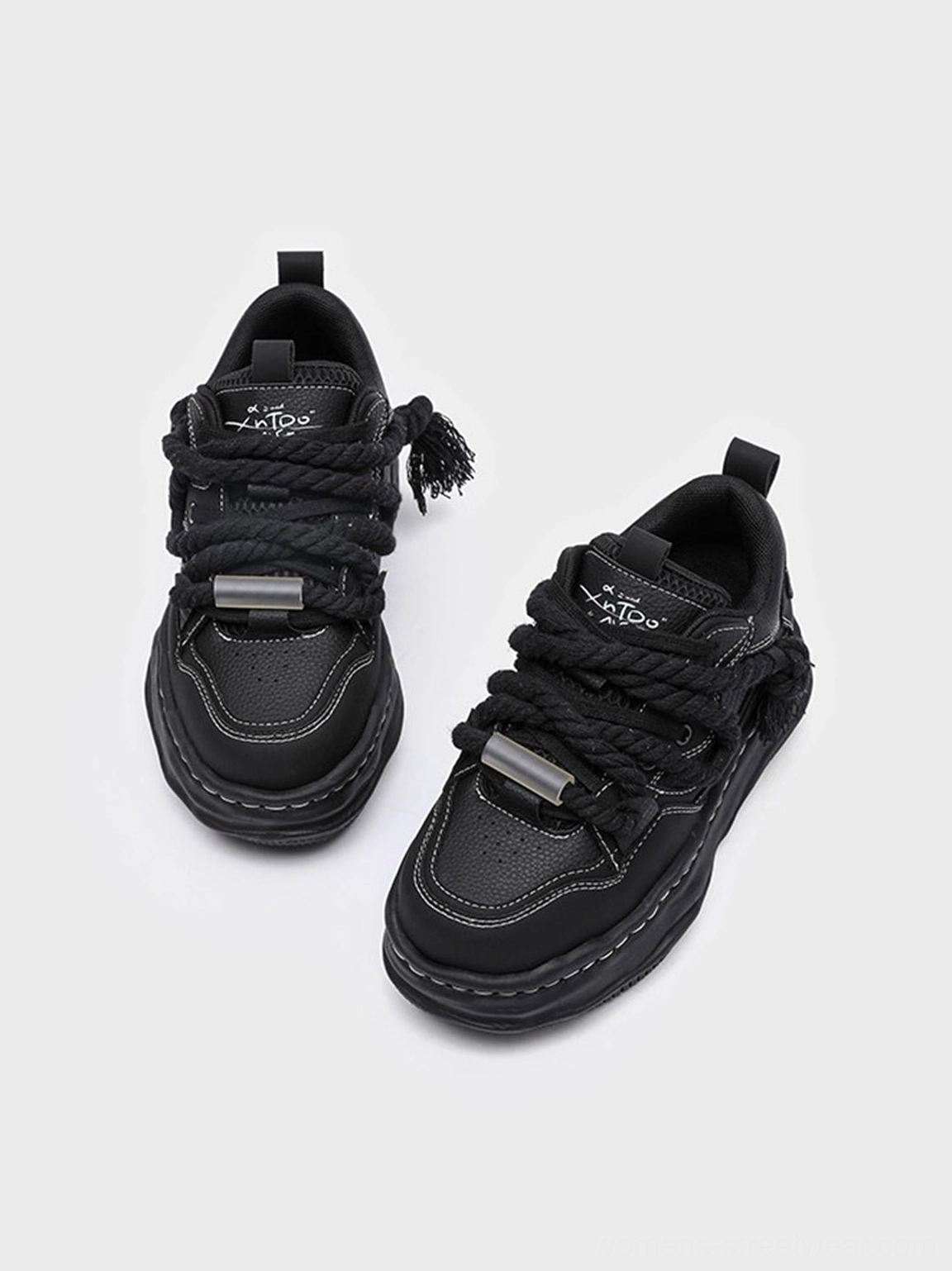All-black platform sneakers with stitched upper panels and bold wavy outsole for Seoul-inspired streetwear outfits