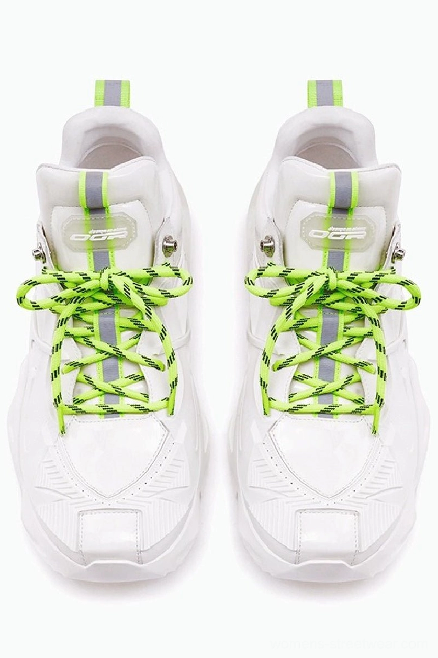 All-white 3D-printed platform sneakers shown from the front with neon green flat laces, reflective heel strips, rounded square toe boxes, and chunky streetwear soles