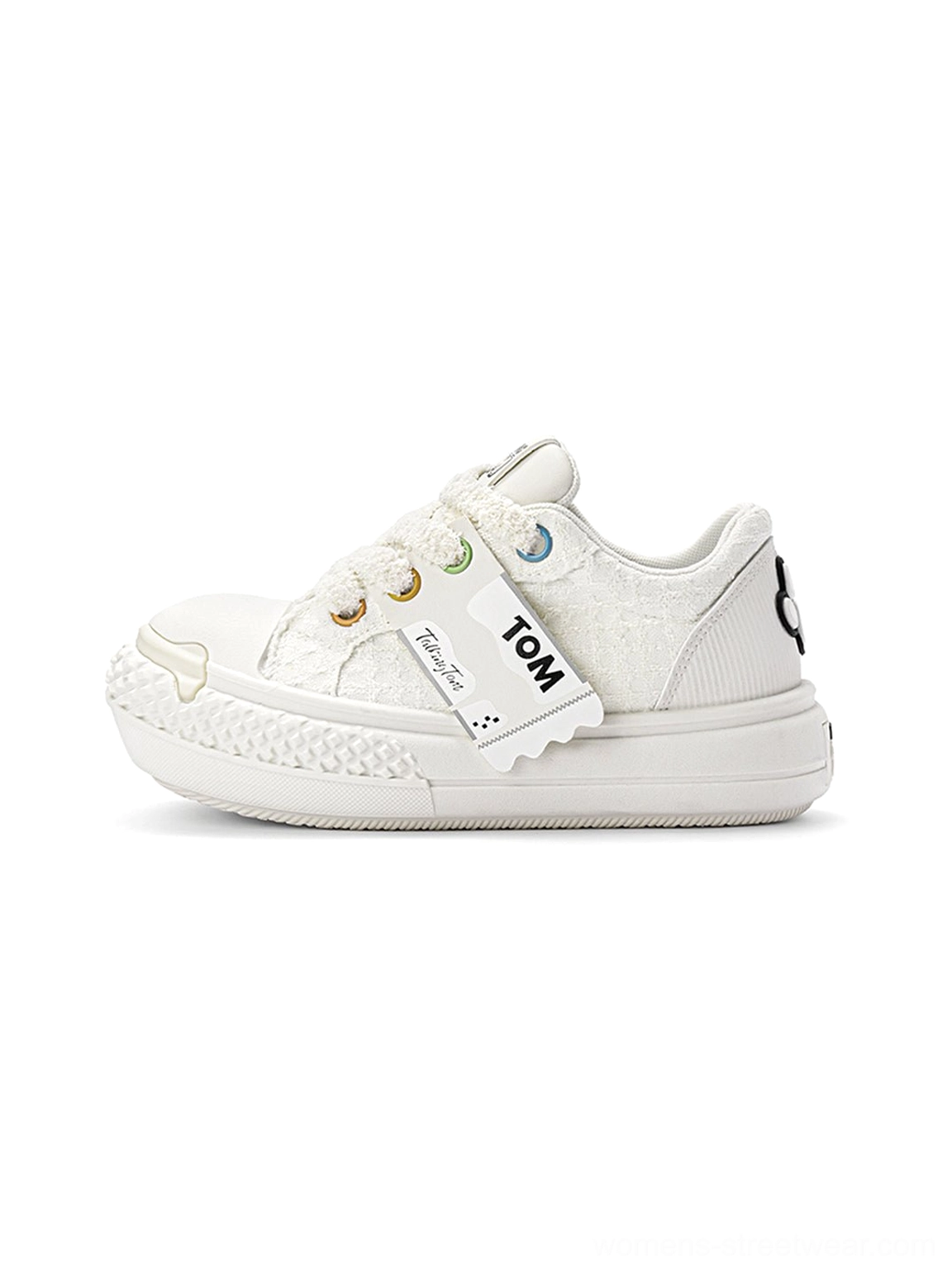 All-white graphic chunky low-top sneakers shown in left side profile with a matching thick sole and decorative side strap
