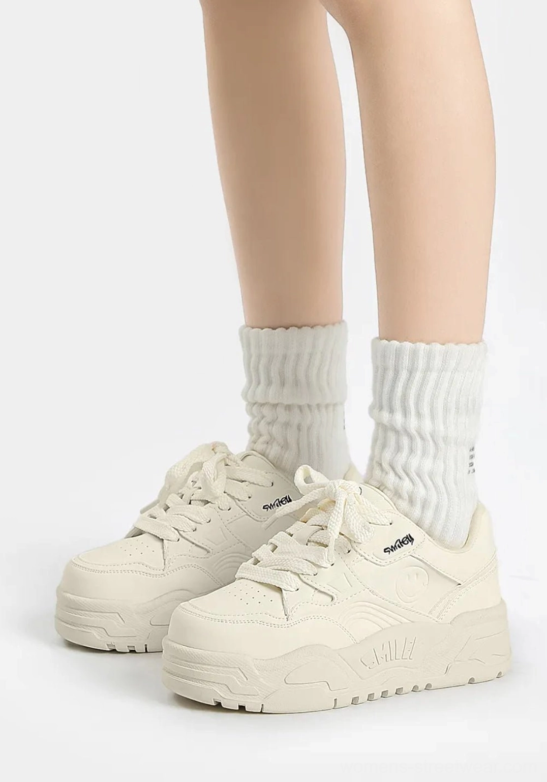 All-white retro platform sneakers shown from a three-quarter front angle with lace-up fastening, smooth upper, and durable thick outsole