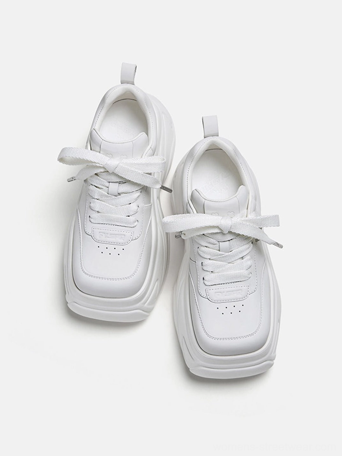 Pair of all-white square-toe platform sneakers shown from above with neat eyelets and a low-top streetwear silhouette
