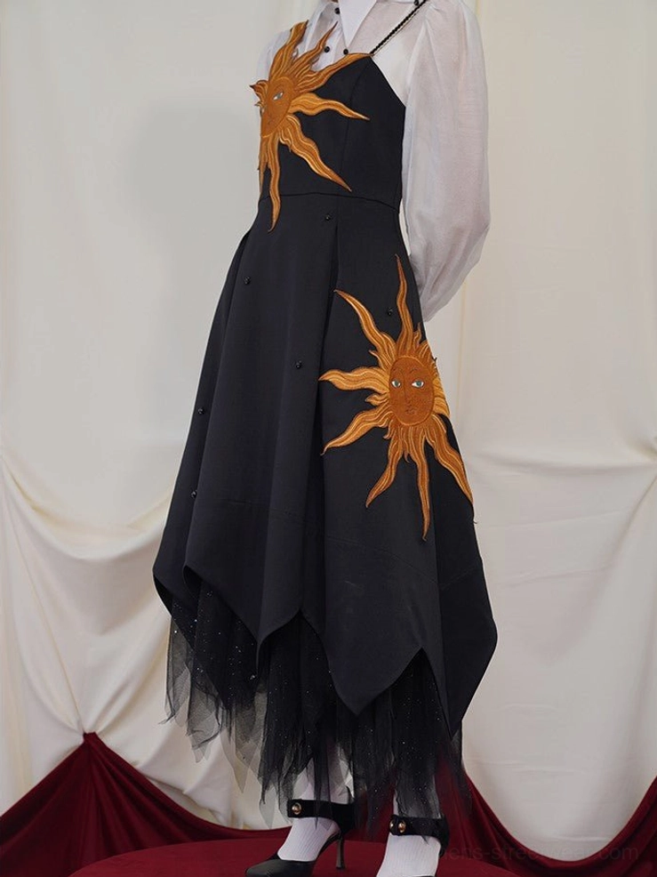 Alternative black slip maxi dress with radiant golden sun embroidery and avant garde asymmetric handkerchief hem