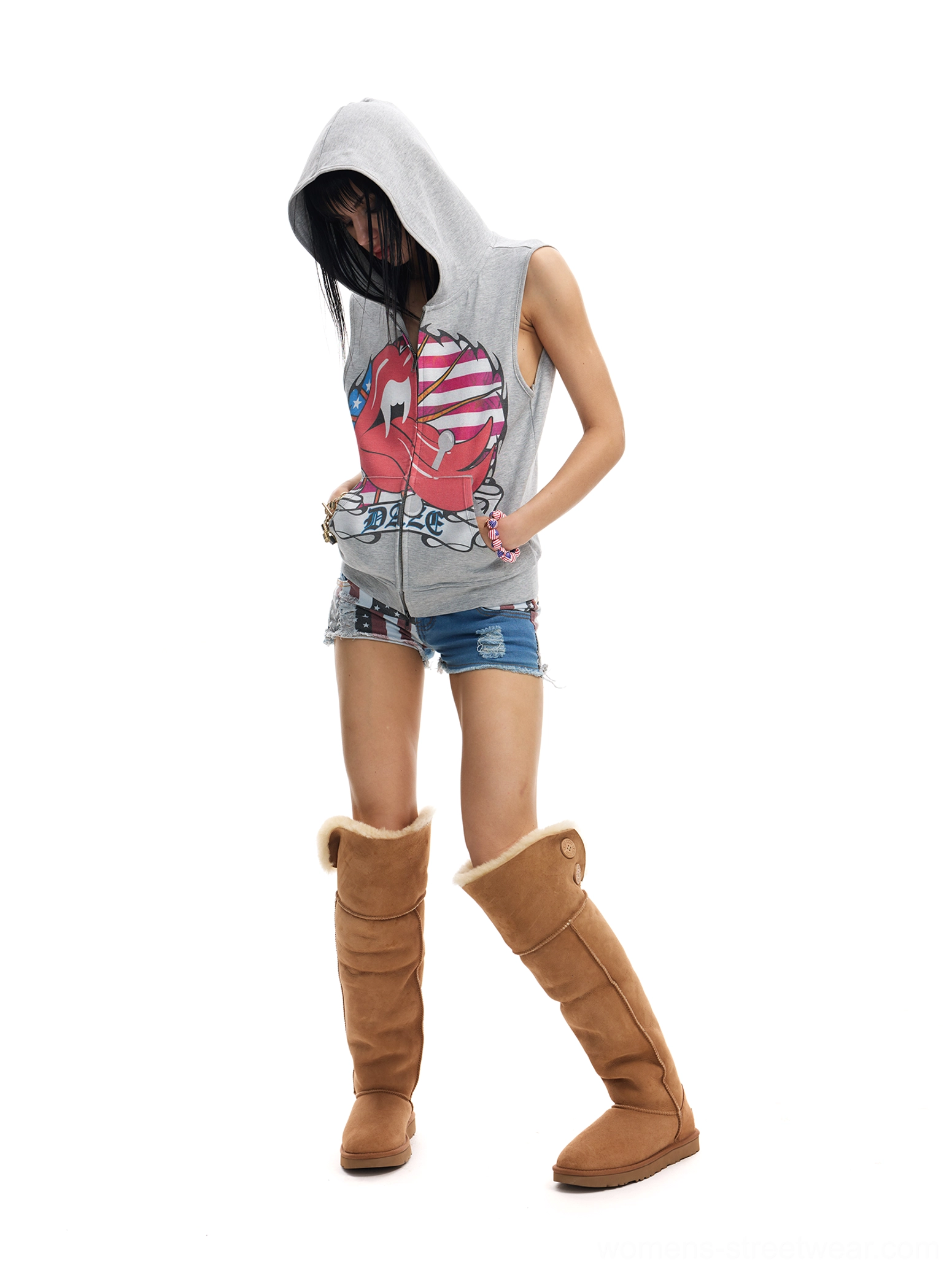 Female model in heather gray Americana flag lips sleeveless hoodie vest styled with knee-high boots
