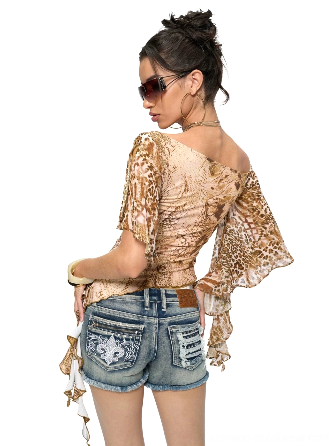 Full back view of a fitted animal print ruffle sleeve top with side tassel detail and low-rise denim shorts