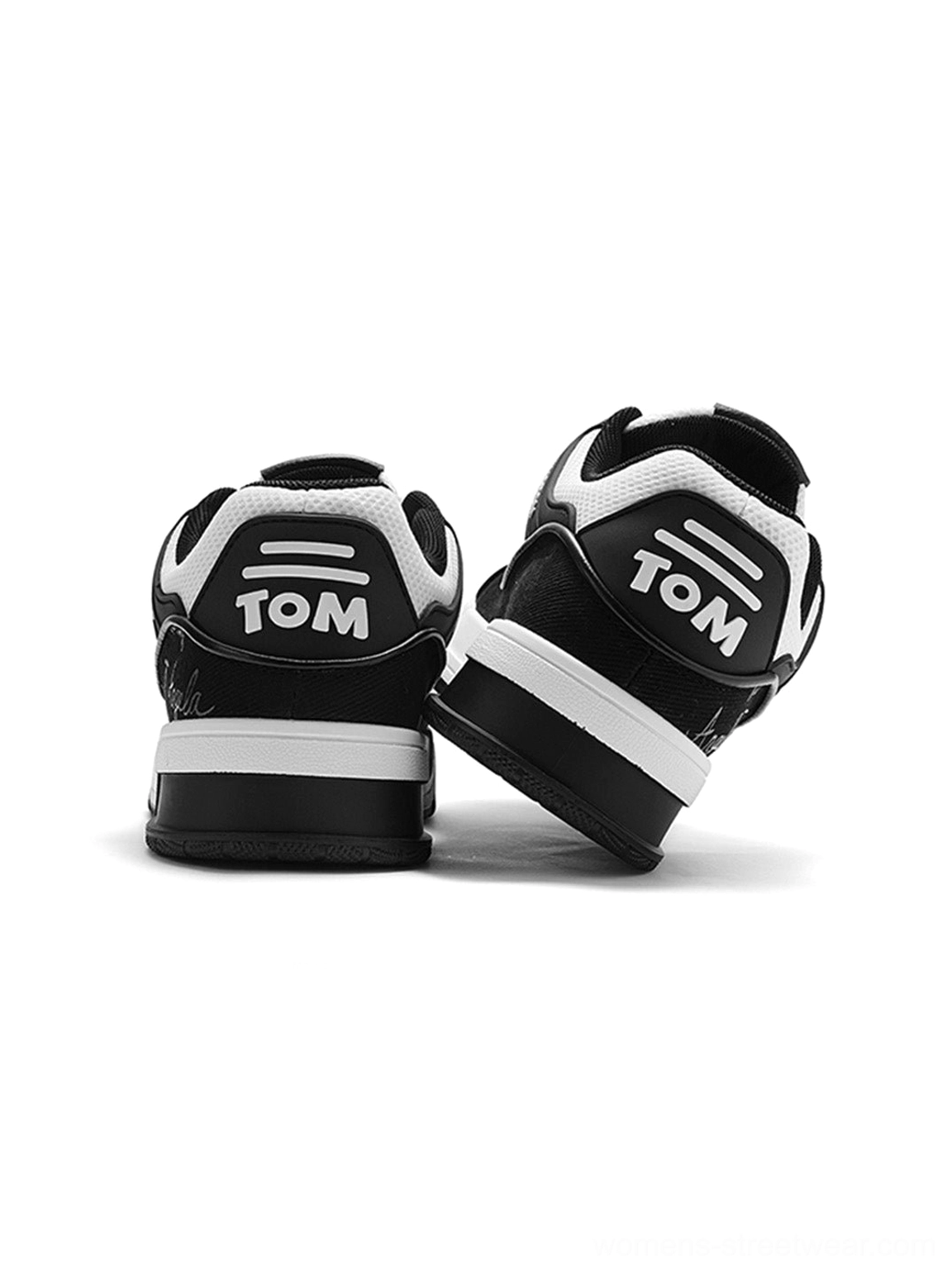 Rear view of black and white anime cat graphic chunky low-top sneakers with contrast heel lettering