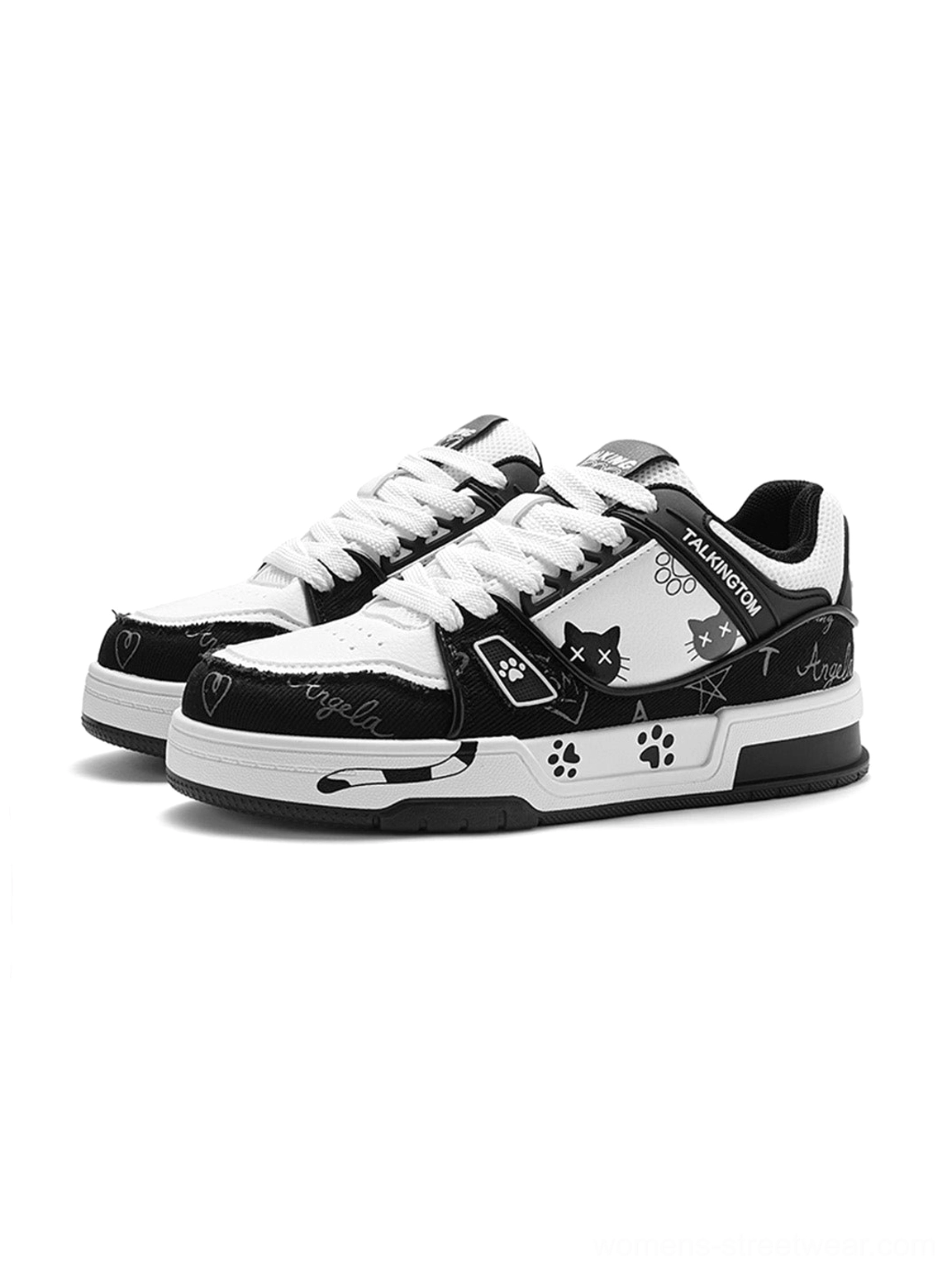 Pair of black and white anime cat graphic low-top sneakers with paw prints star details and chunky layered soles