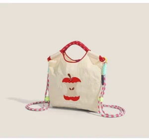 Front view of off white apple core embroidered canvas mini tote bag with red contrast trim