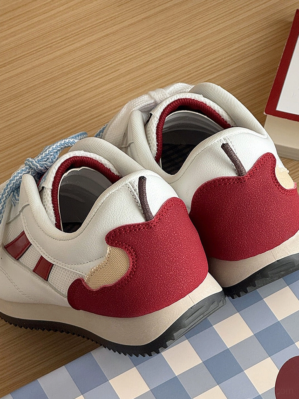 Back heel view of women’s apple detail red mesh retro runner sneakers showing wine red heel panels and beige accents