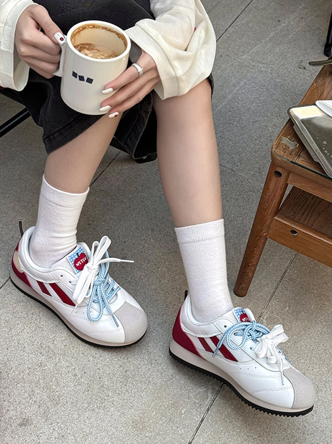 Indoor casual outfit with apple detail red mesh retro runner sneakers worn with white mid-calf socks