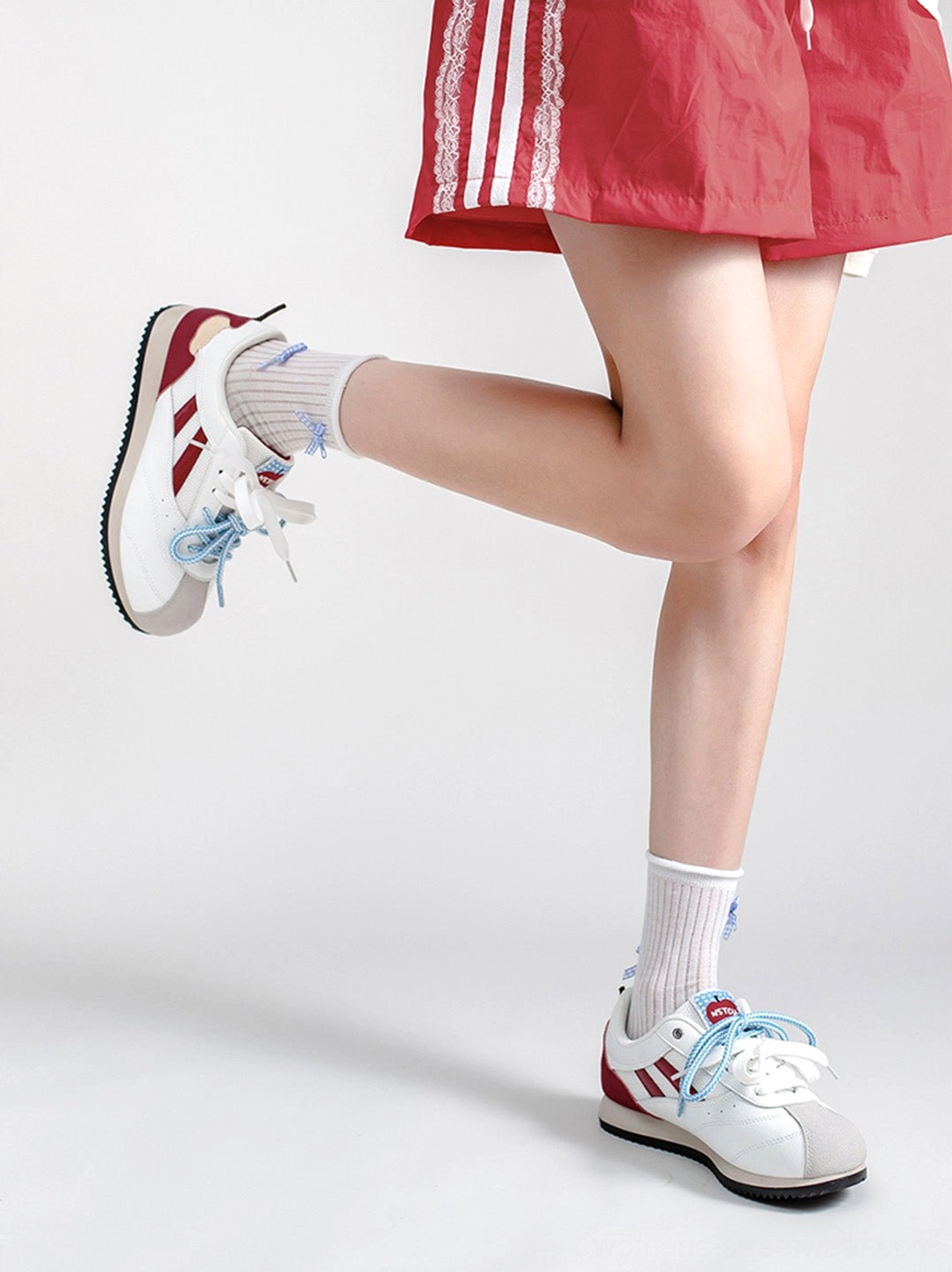 Apple detail red mesh retro runner sneakers for women displaying vintage sport styling and chunky ridged outsole