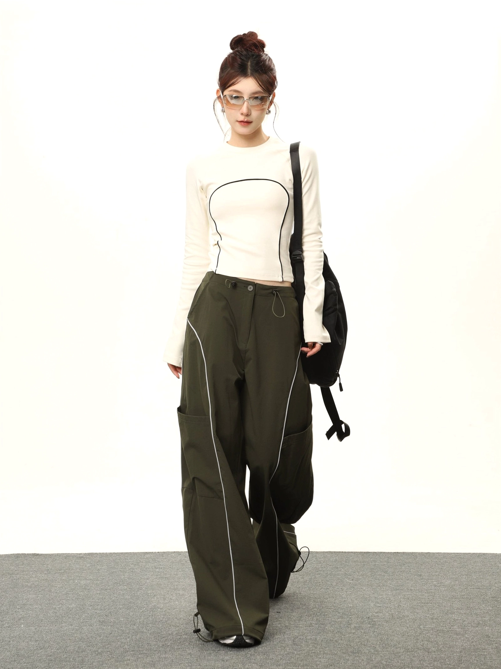 Apricot contrast stitch cropped long sleeve streetwear top worn with olive wide leg cargo pants front full body view