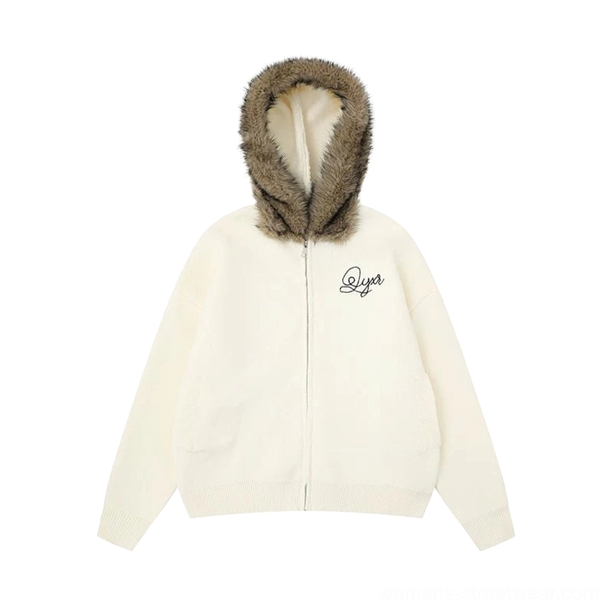 Flat lay view of the Apricot faux fur trim zip hoodie jacket showing the light body color, dark hood trim, zipper, and chest embroidery