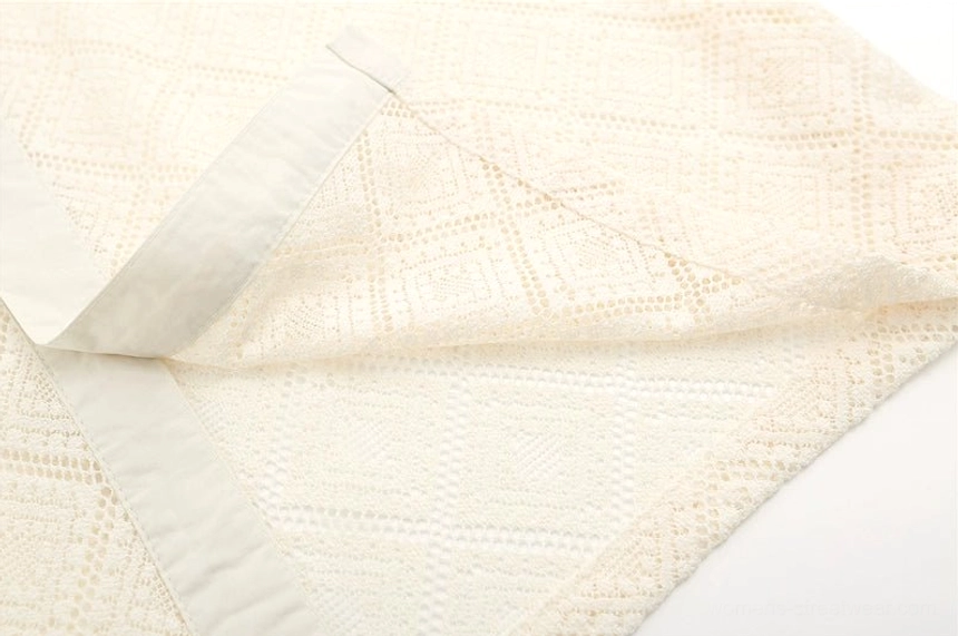 Close-up of apricot geometric lace shirt edge binding and neat semi-sheer openwork seam detail