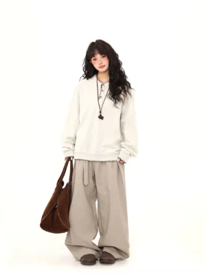 Oversized apricot Henley sweatshirt with contrast whip-stitch trim and half-button neckline full outfit view