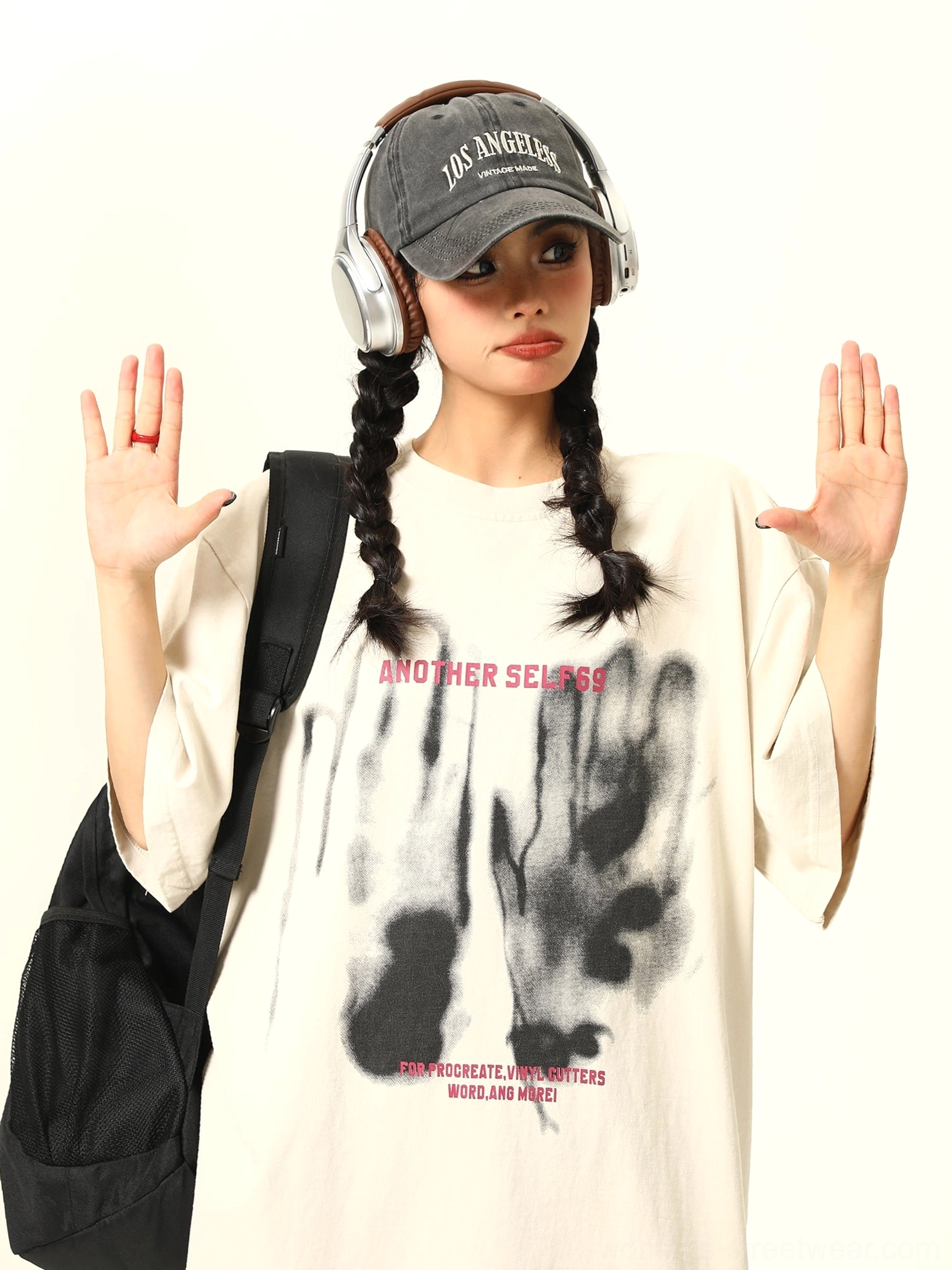 Front view of apricot oversized shadow print graphic T-shirt with relaxed dropped shoulder silhouette and expressive streetwear artwork