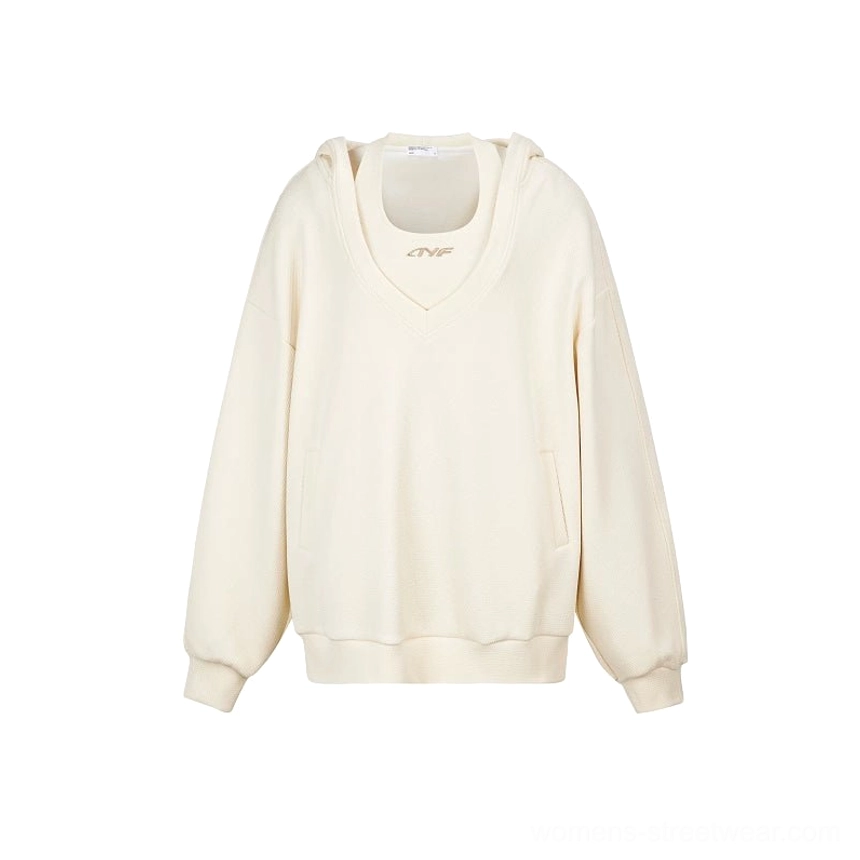 Apricot oversized V-neck hoodie sweatshirt flat lay showing solid color design, kangaroo pocket, ribbed cuffs, ribbed hem, and chest emblem