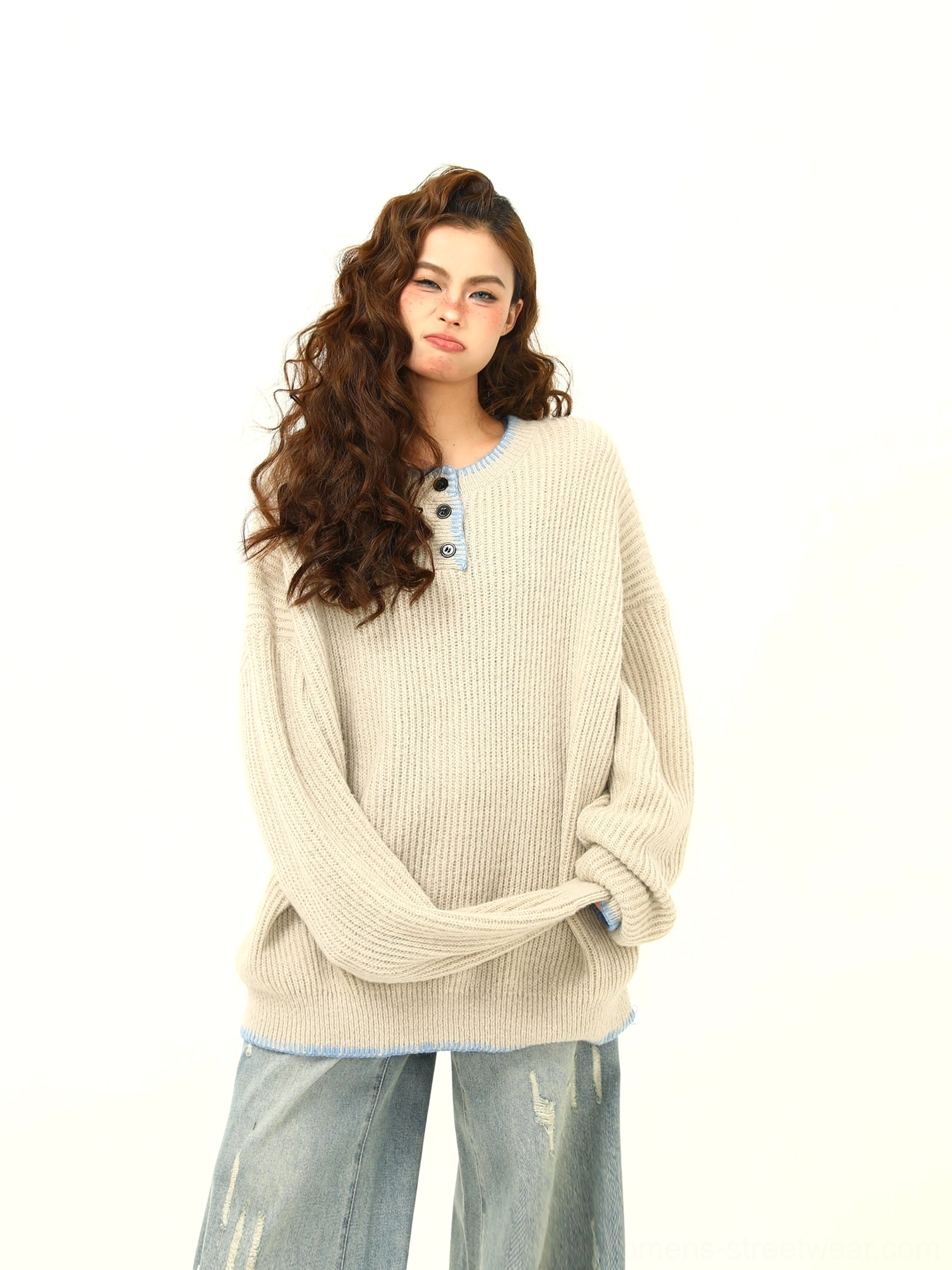 Apricot oversized ribbed Henley knit sweater in three-quarter view with contrast neckline and relaxed streetwear styling
