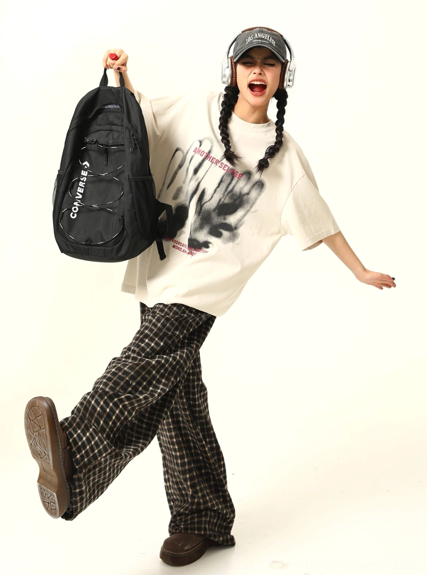 Side view of apricot oversized selfie graphic streetwear T-shirt showing its relaxed drape and casual urban silhouette