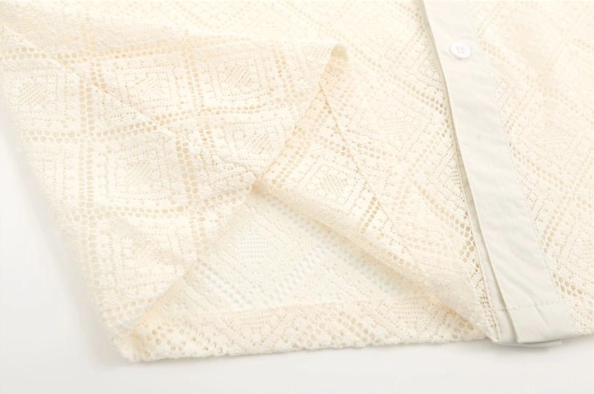 Apricot sheer geometric lace button-up shirt close-up with white buttons and clean front placket