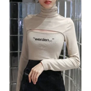 Close-up front view of apricot slim knit turtleneck top with framed chest cutout and minimal graphic lettering