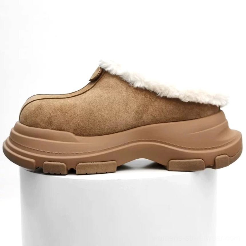 Apricot-tan fleece-lined platform clog on a white display plinth showing the soft suede-finish upper, fluffy collar, and rugged tread outsole