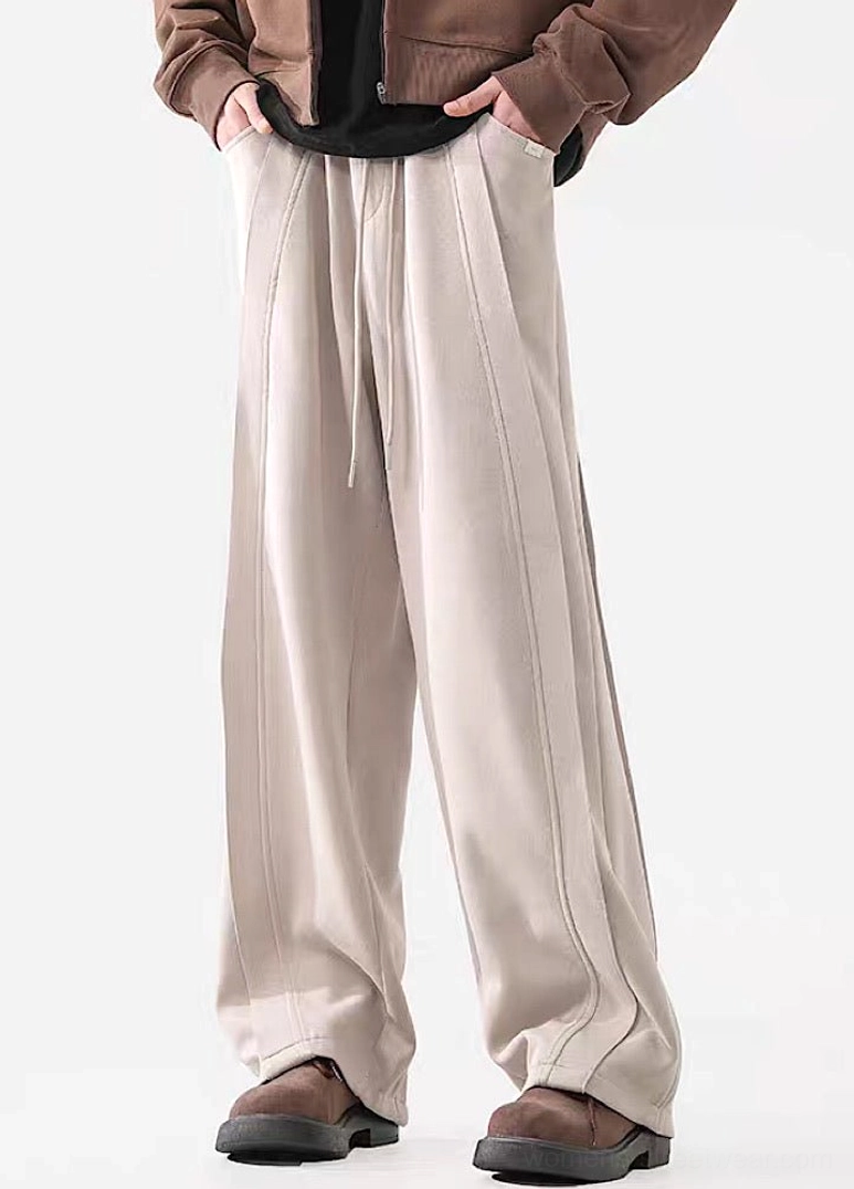 Front view of light Apricot wide-leg streetwear pants with drawstring waist and clean neutral urban styling