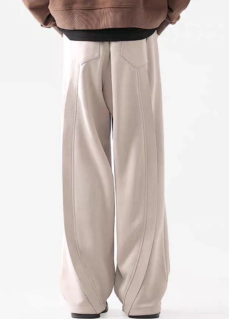 Rear view of light Apricot wide-leg streetwear pants showing relaxed silhouette and detailed back waistband
