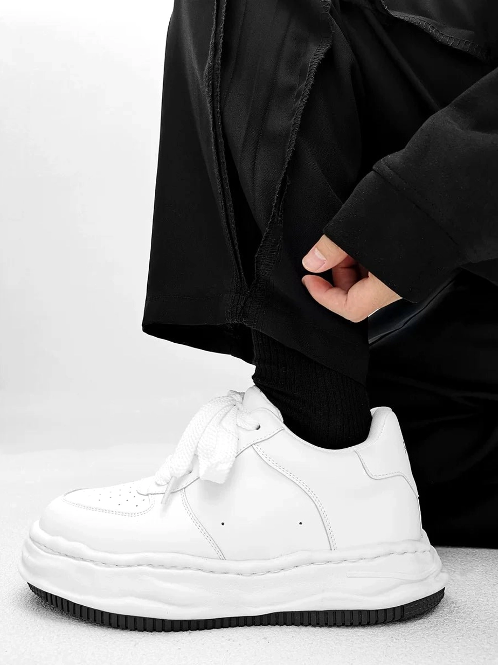 Arctic Crest white leather platform sneakers with subtle toe perforations and layered thick midsole