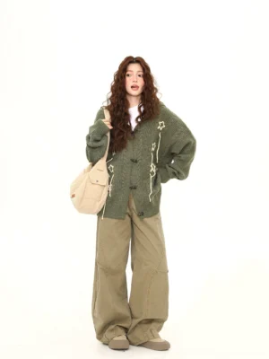 Army green oversized bunny ear hooded knit cardigan styled with khaki wide leg pants and canvas tote bag