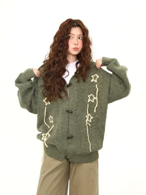 Army green bunny ear toggle knit cardigan front upper body view with star tie embellishments and cable knit texture