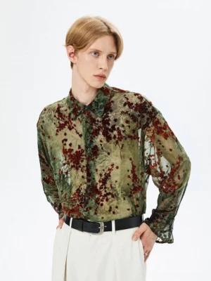 Front three-quarter view of an army green floral print semi-sheer streetwear button-up shirt with dark red botanical patterns on a male model