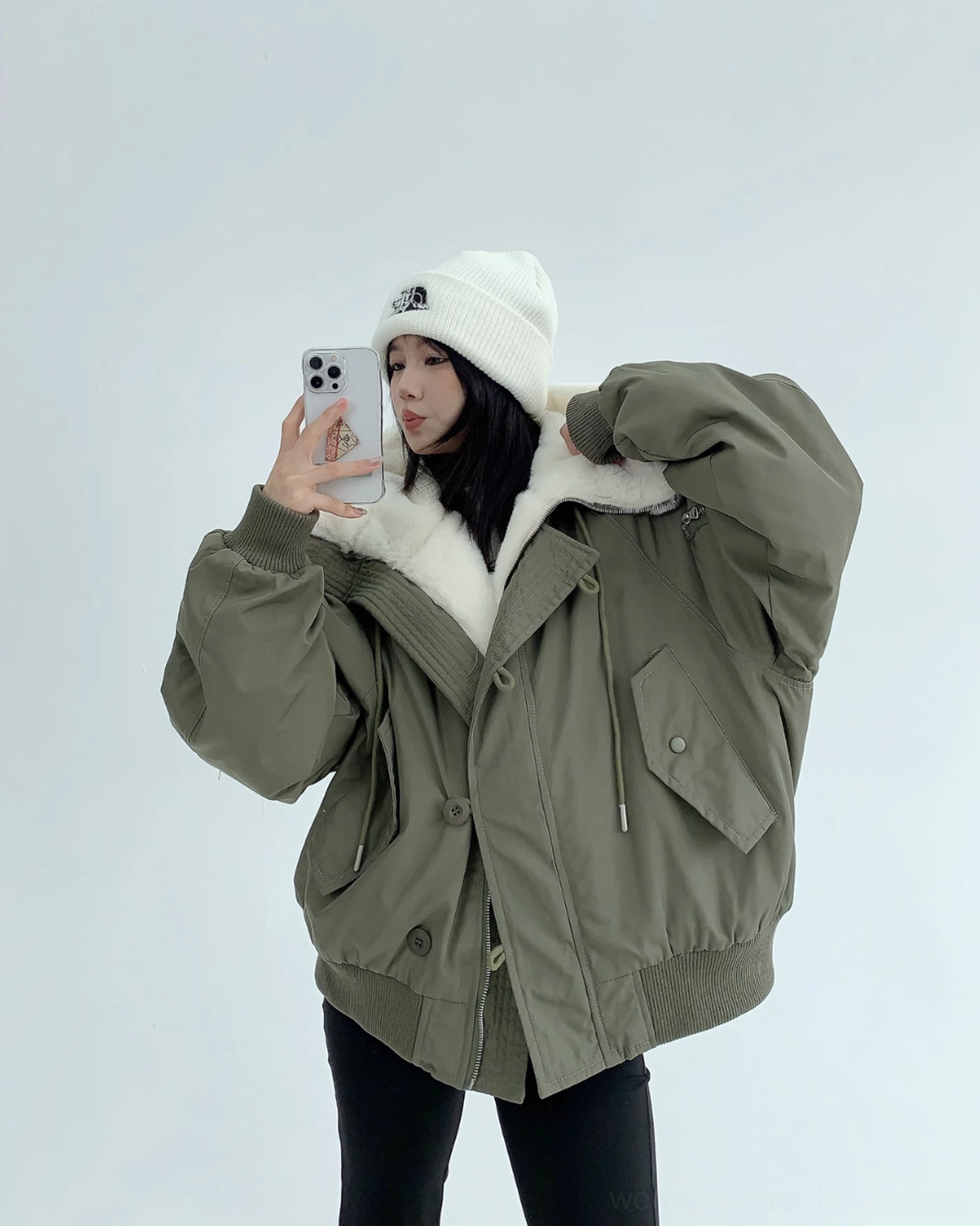 Front mirror view of oversized army green streetwear bomber jacket with button placket, utility pocket, and drop shoulders