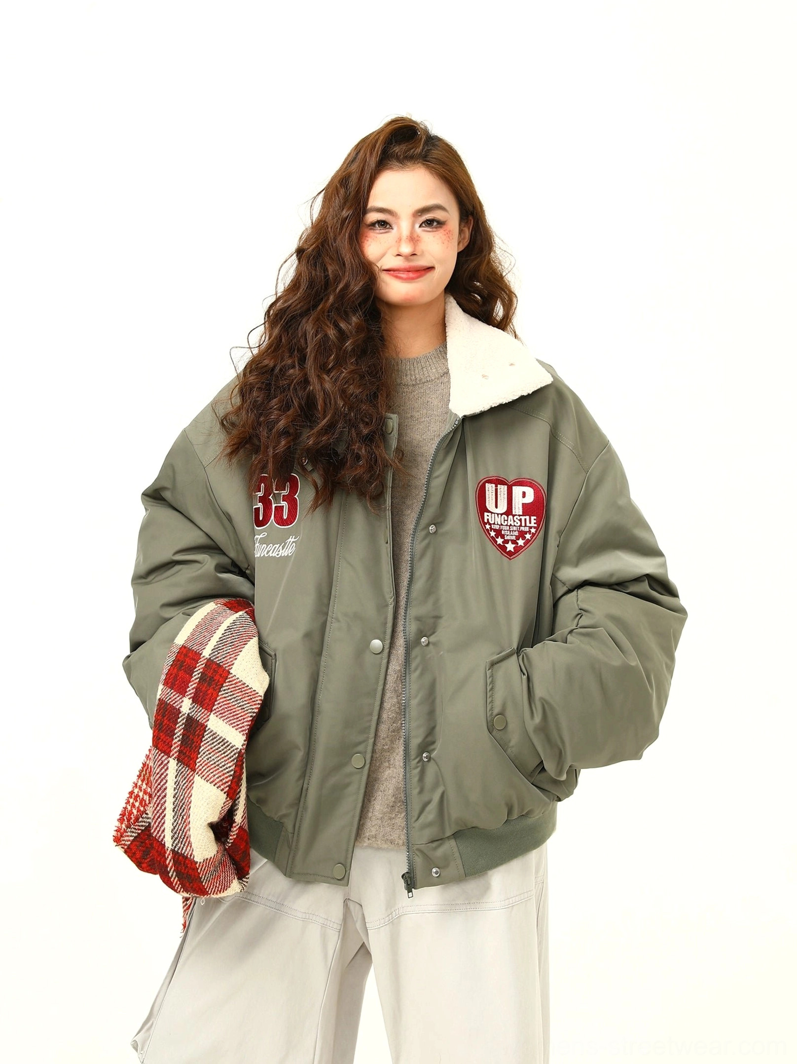Army green varsity patch bomber jacket showing fleece collar snap-button front and side pockets