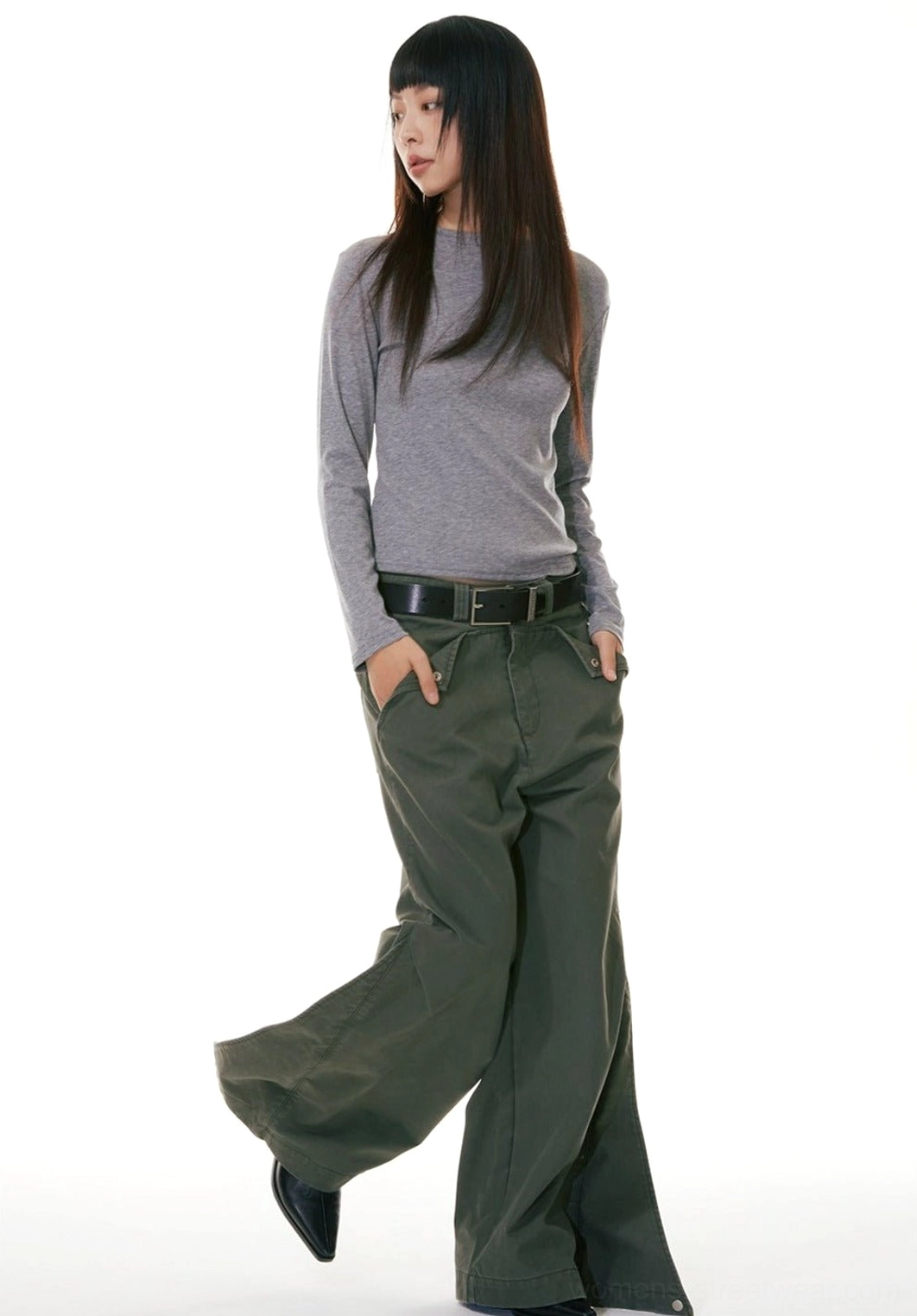 Army green wide-leg denim workwear jeans with a leather waist belt shown in a three-quarter side streetwear styling view