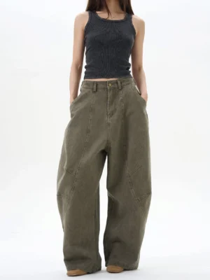 Female model wearing army green wide leg pleated denim pants with a cropped black tank top in a Korean streetwear outfit
