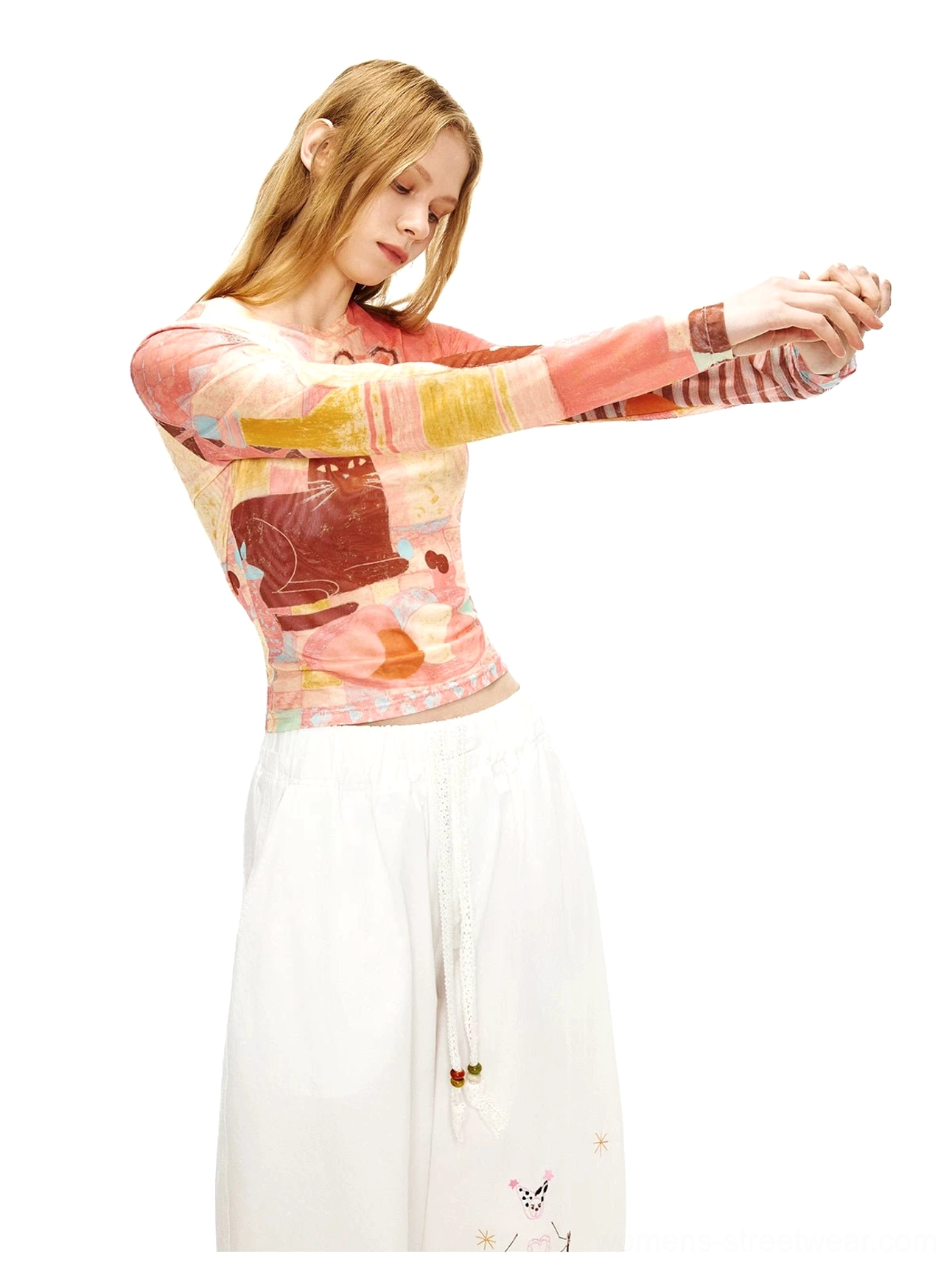 Pastel gradient art print sheer mesh long sleeve crop top shown in a side stretching pose