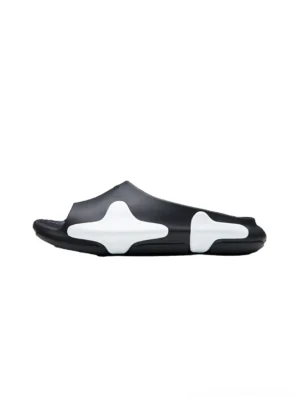 Black and white asymmetric colorblock cloud cushion slide sandal side profile on a clean white background