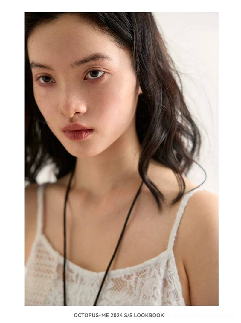 Asymmetric crochet lace cami top in off white featuring delicate open-knit construction, floral lace accents, and a long uneven streetwear hem